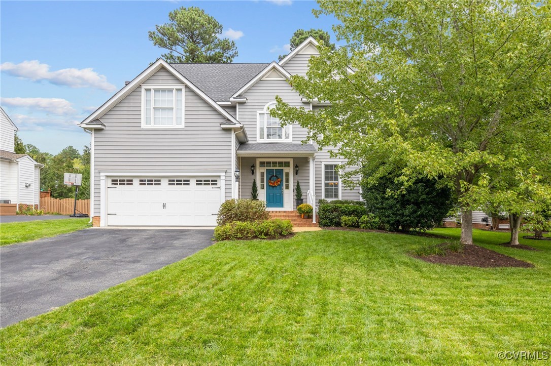 a view of a house with a yard and pathway