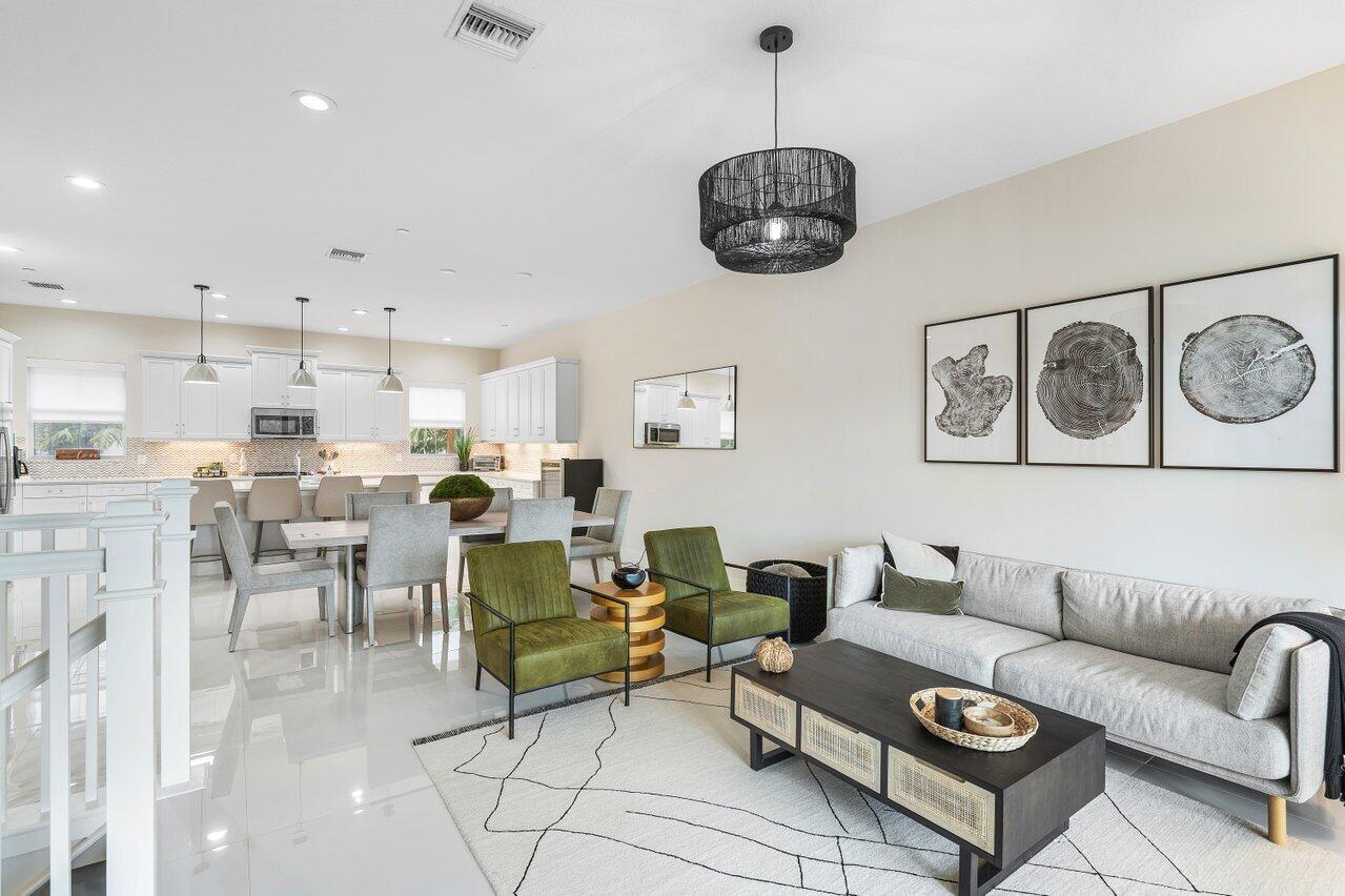 a living room with furniture kitchen and a chandelier