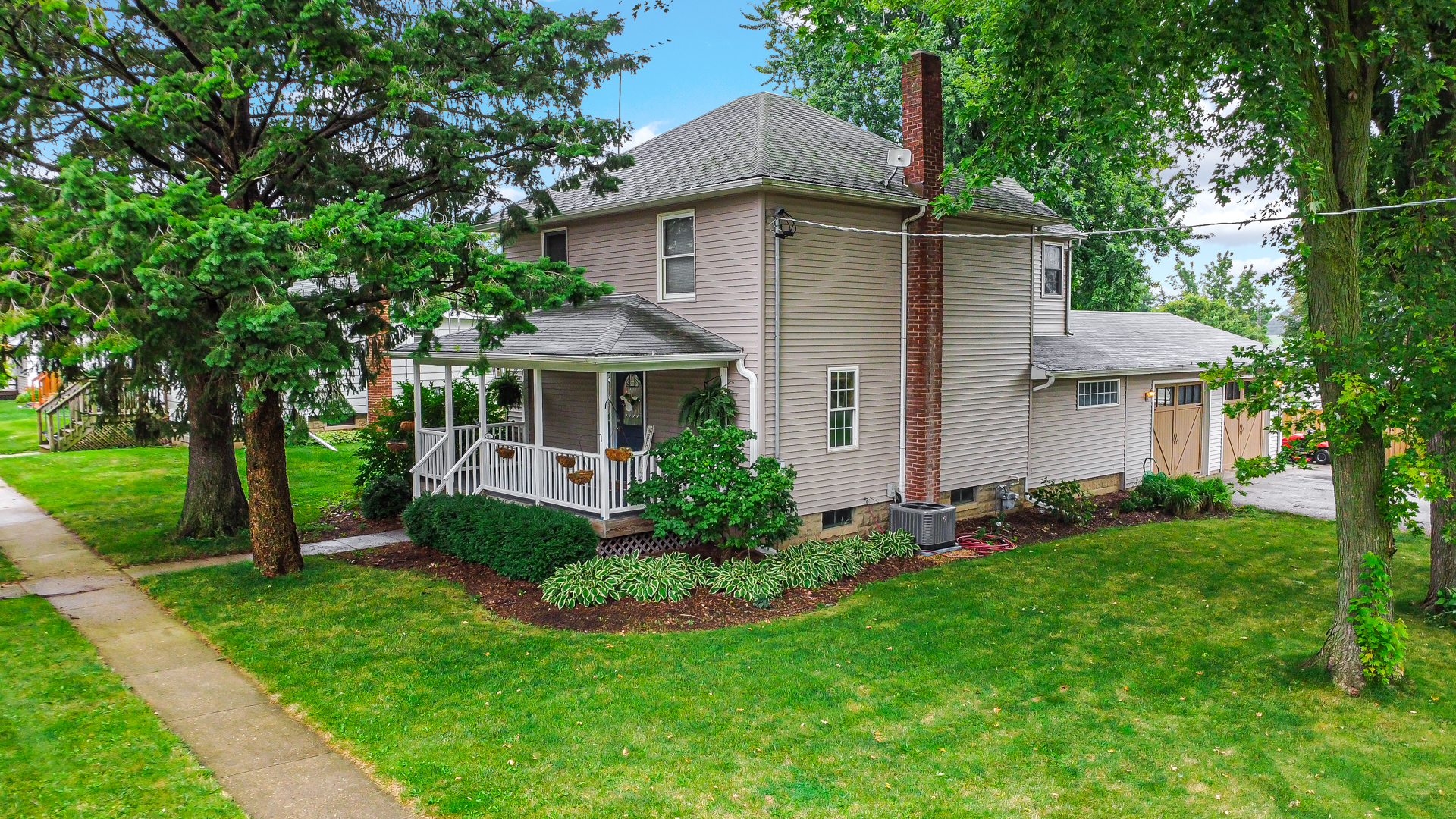 a front view of a house with a garden