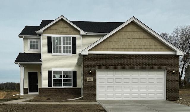 a front view of a house with a garage