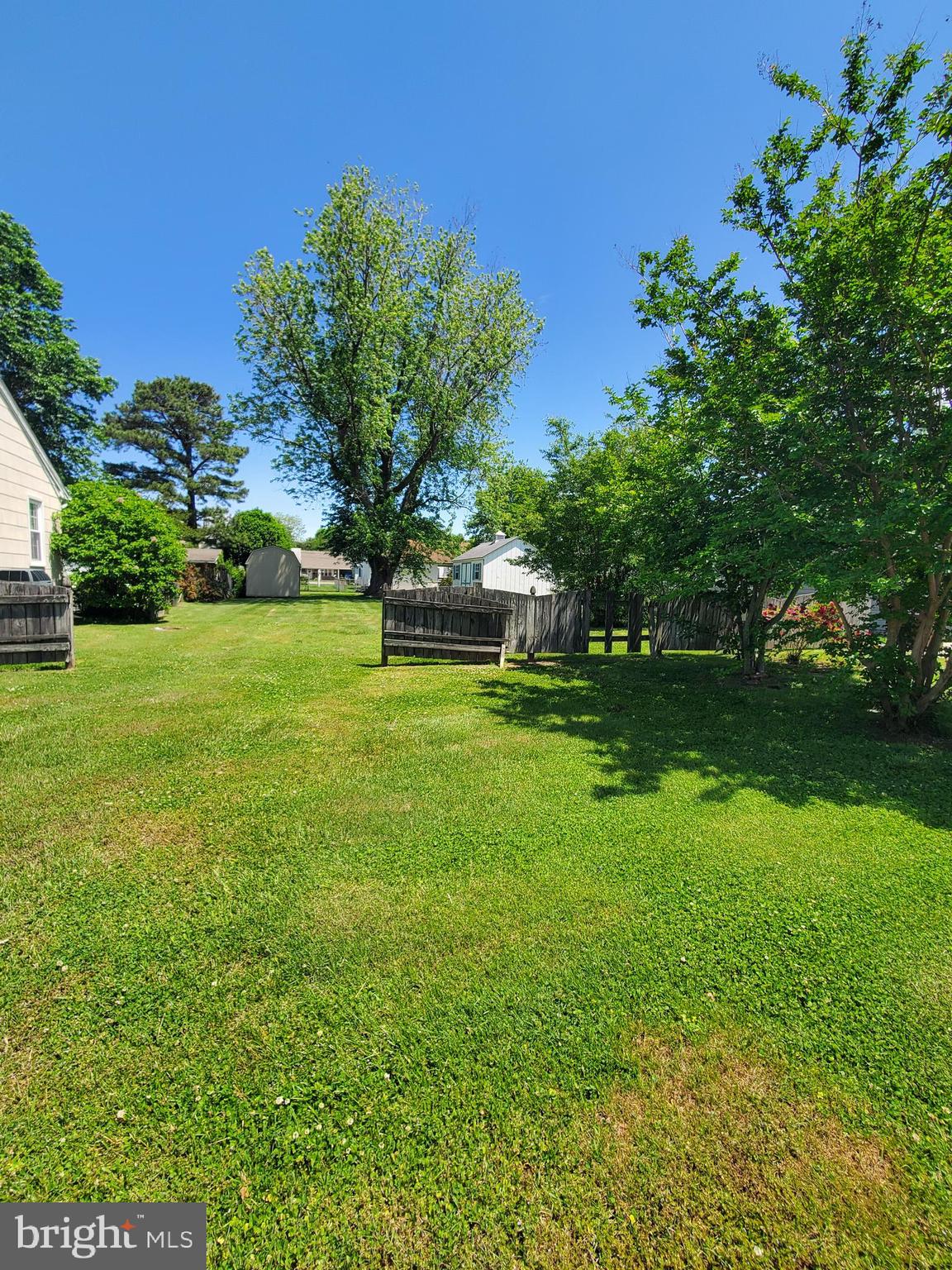 a view of a garden with a building in the background