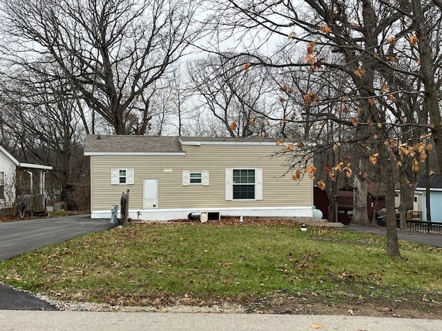 a front view of house with yard and trees