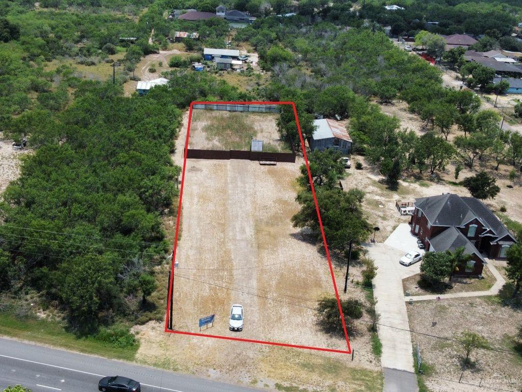 an aerial view of a house with a yard and trees