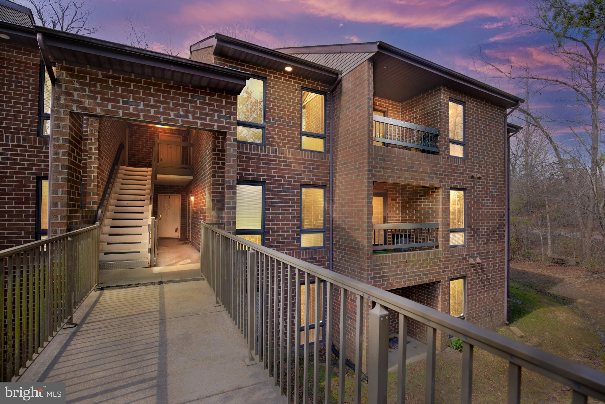 a view of a brick house with many windows