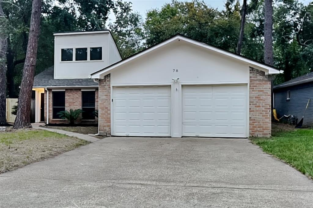 a view of a white house with a yard and garage