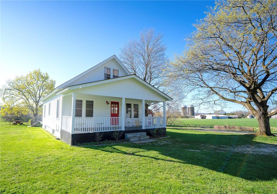 a front view of house with yard and green space