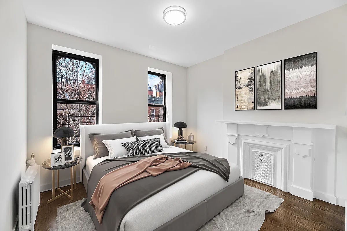 a bedroom with a bed and a painting on the wall