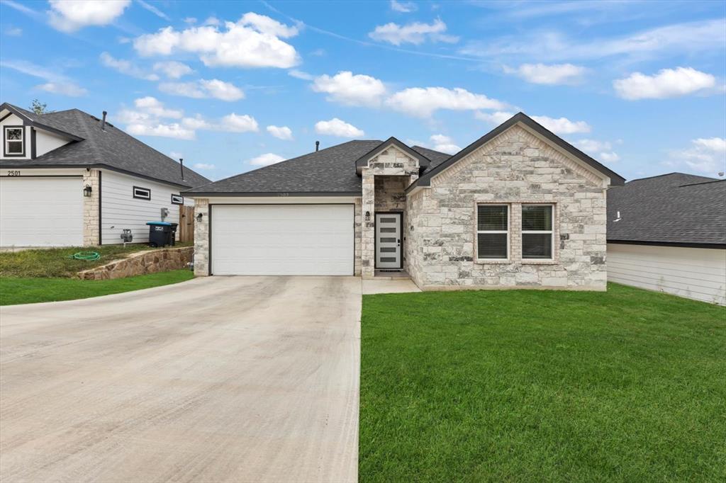 a front view of a house with a yard and garage