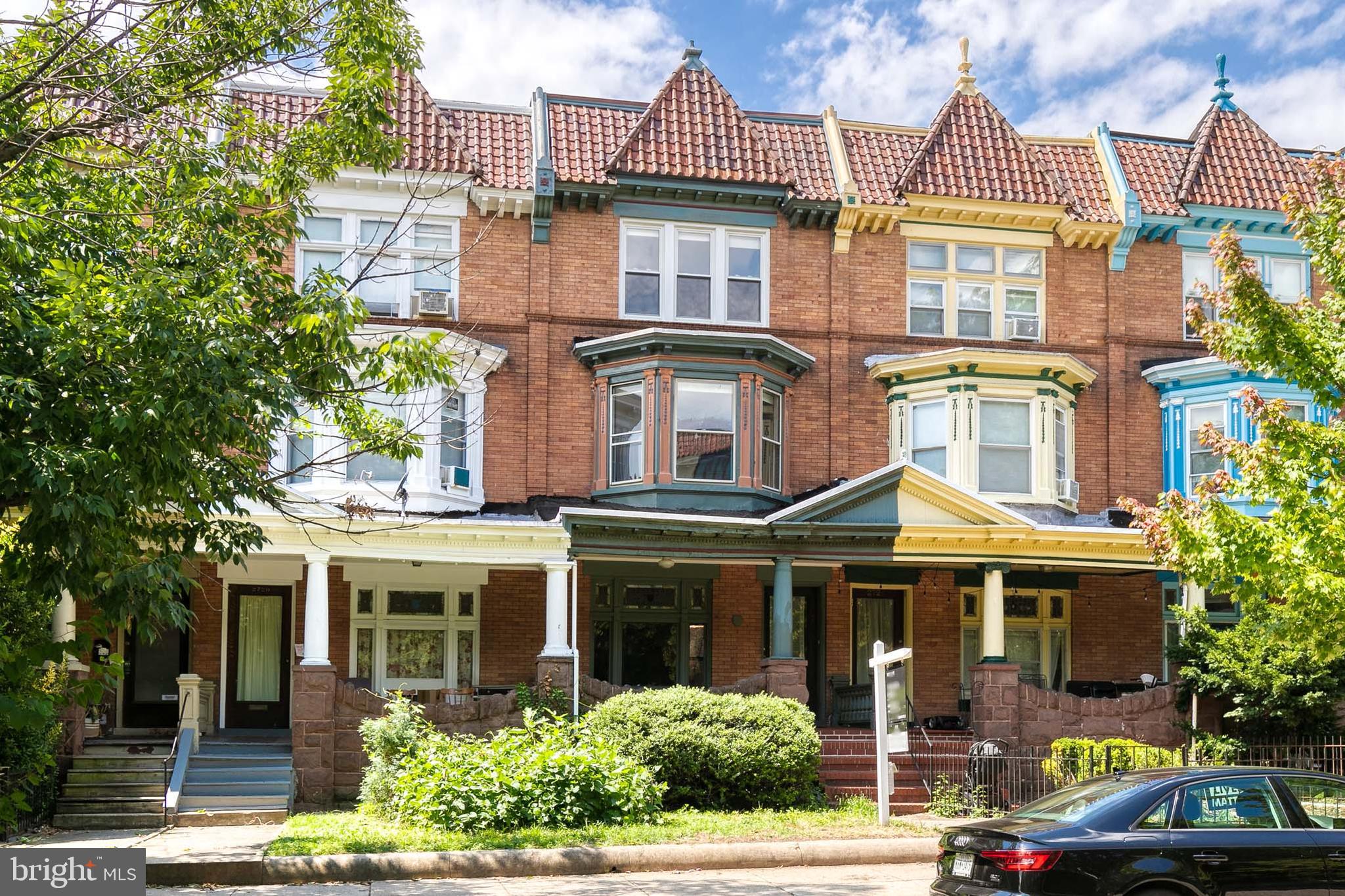 a front view of a residential apartment building with a yard