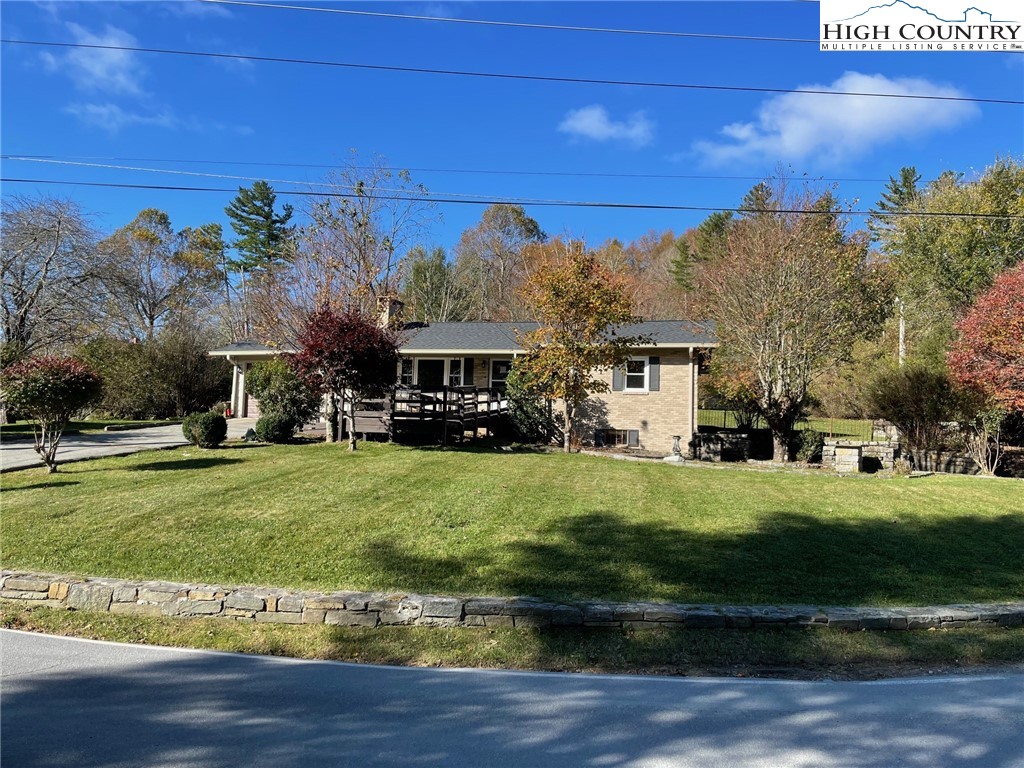 a view of an house with backyard space and garden