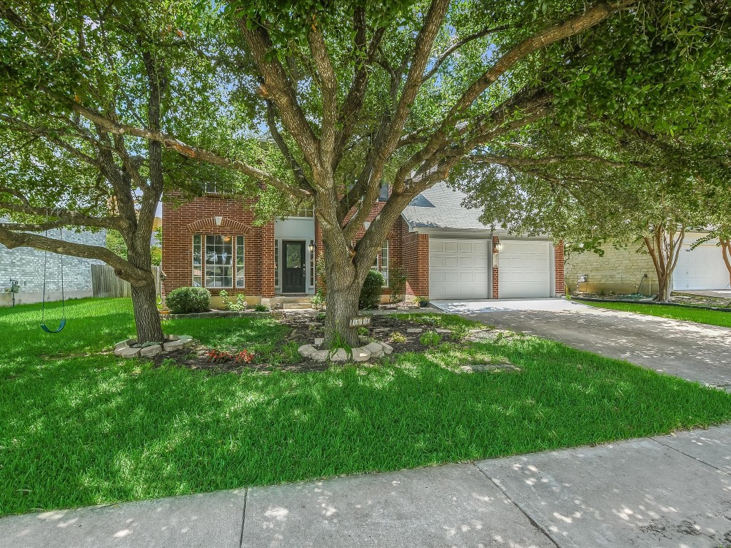 a front view of house with yard and green space