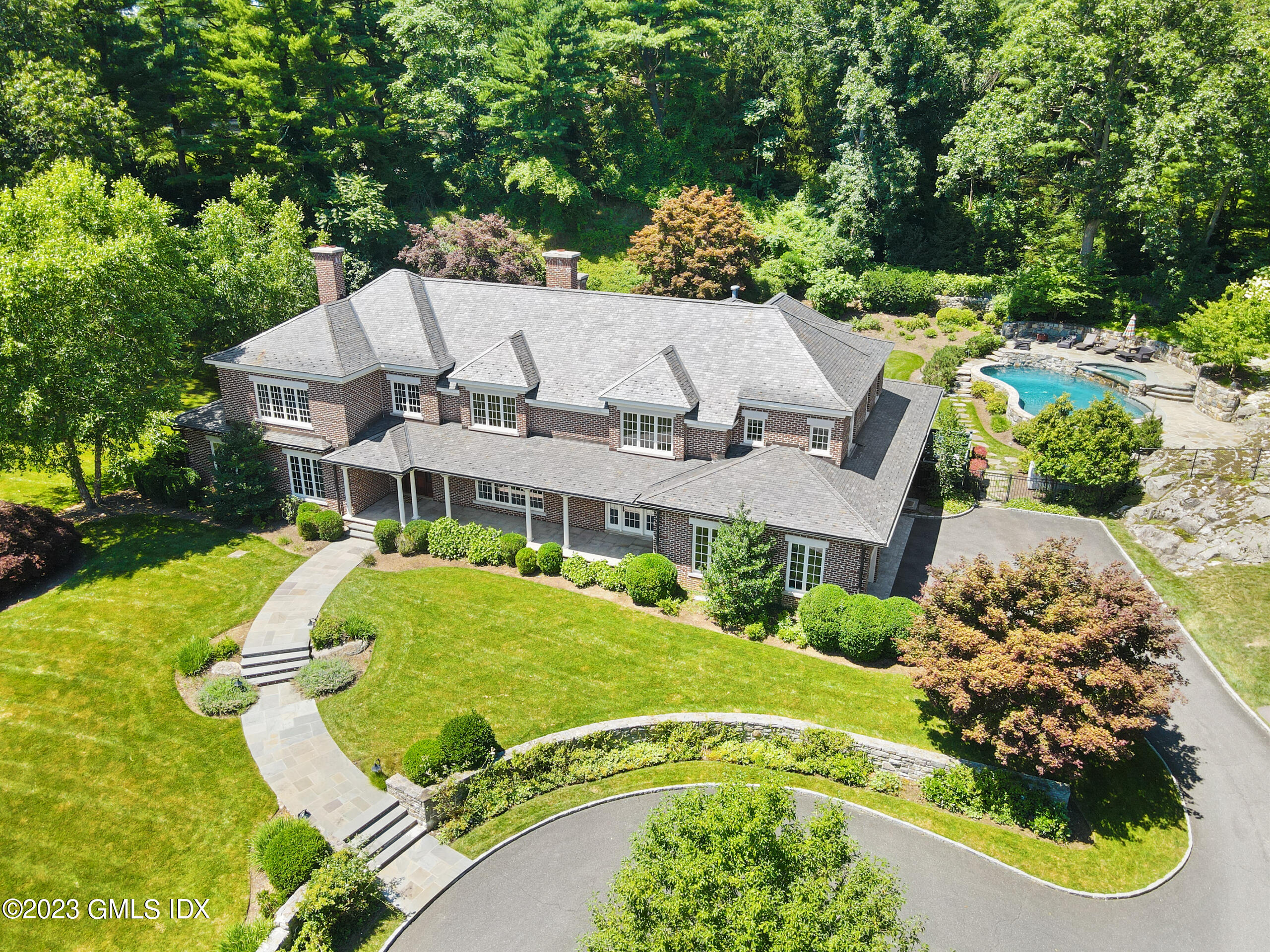 an aerial view of a house with a yard basket ball court and outdoor seating