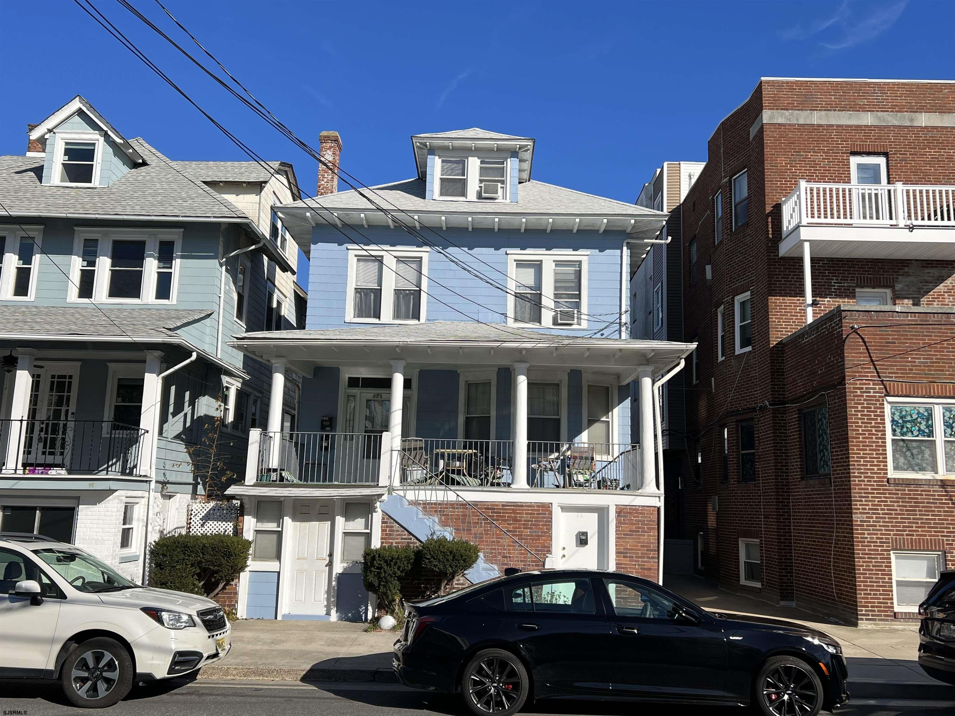 a front view of a building and car parked