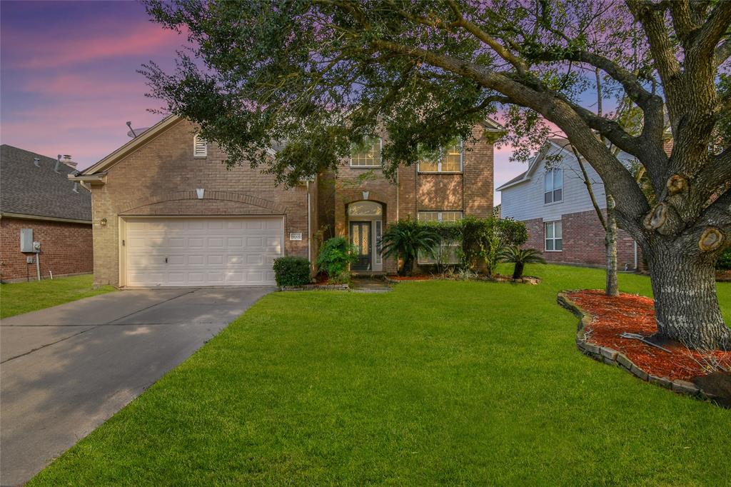 Welcome 9005 Sundown, a stunning, fully renovated home with a timeless red brick façade, lush landscaping, and a light-filled formal entry.