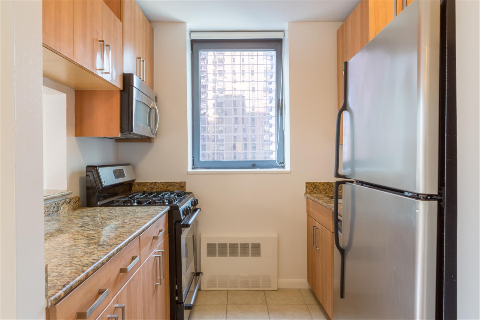 a kitchen with a refrigerator and a stove top oven