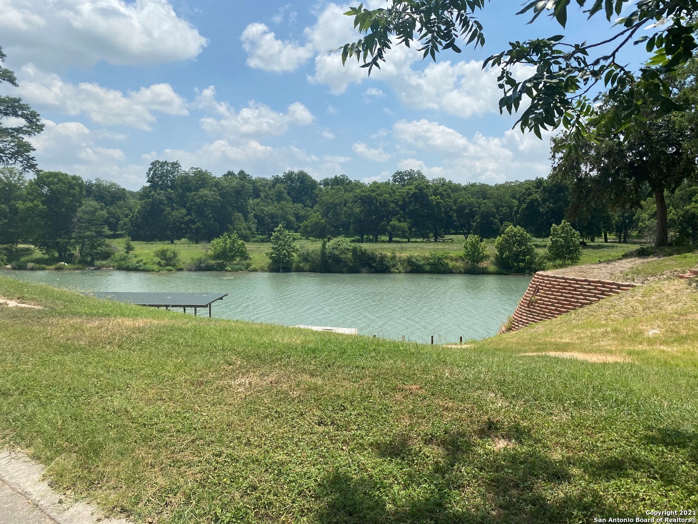 a view of a lake with houses in the back