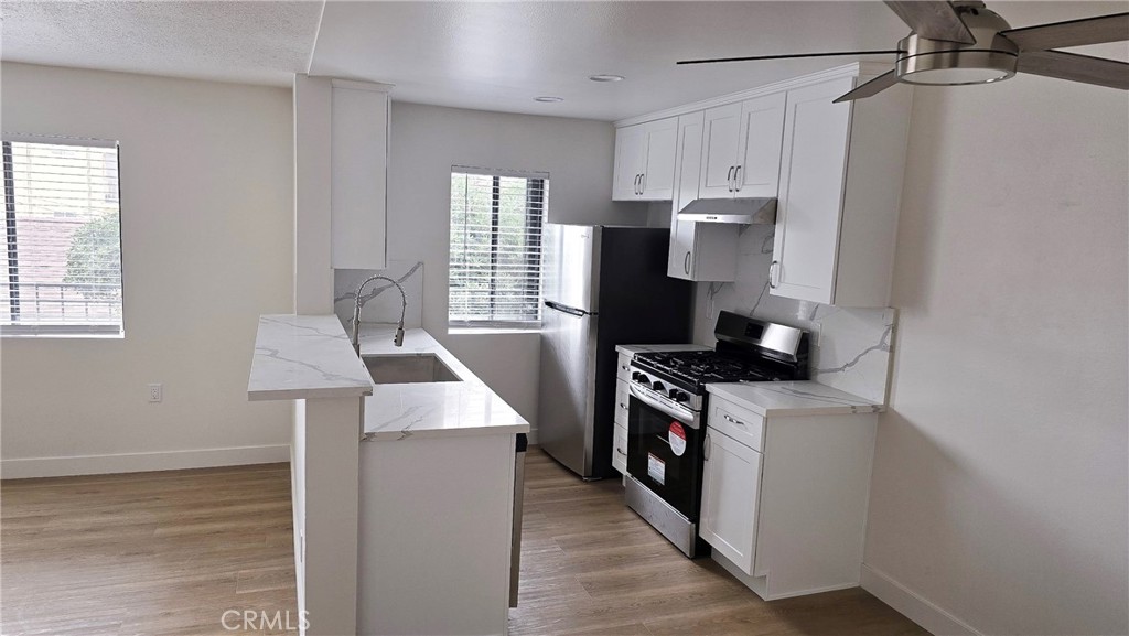 a kitchen with a stove and a refrigerator