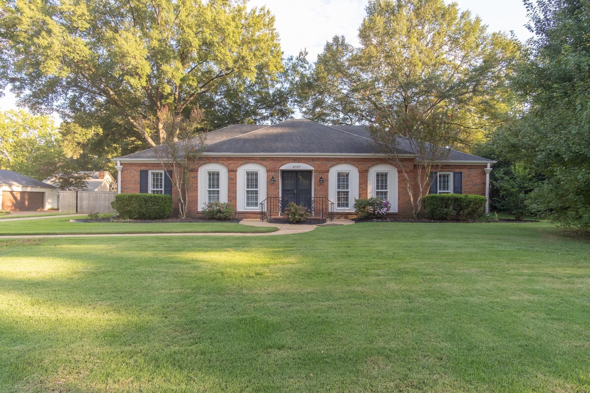 Single story home with a front lawn