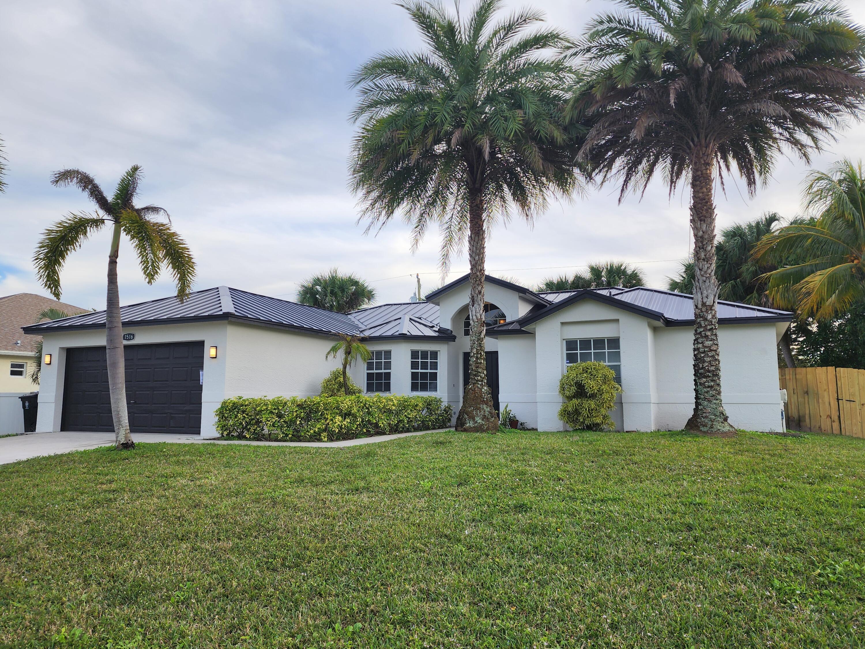 a front view of house with yard and trees