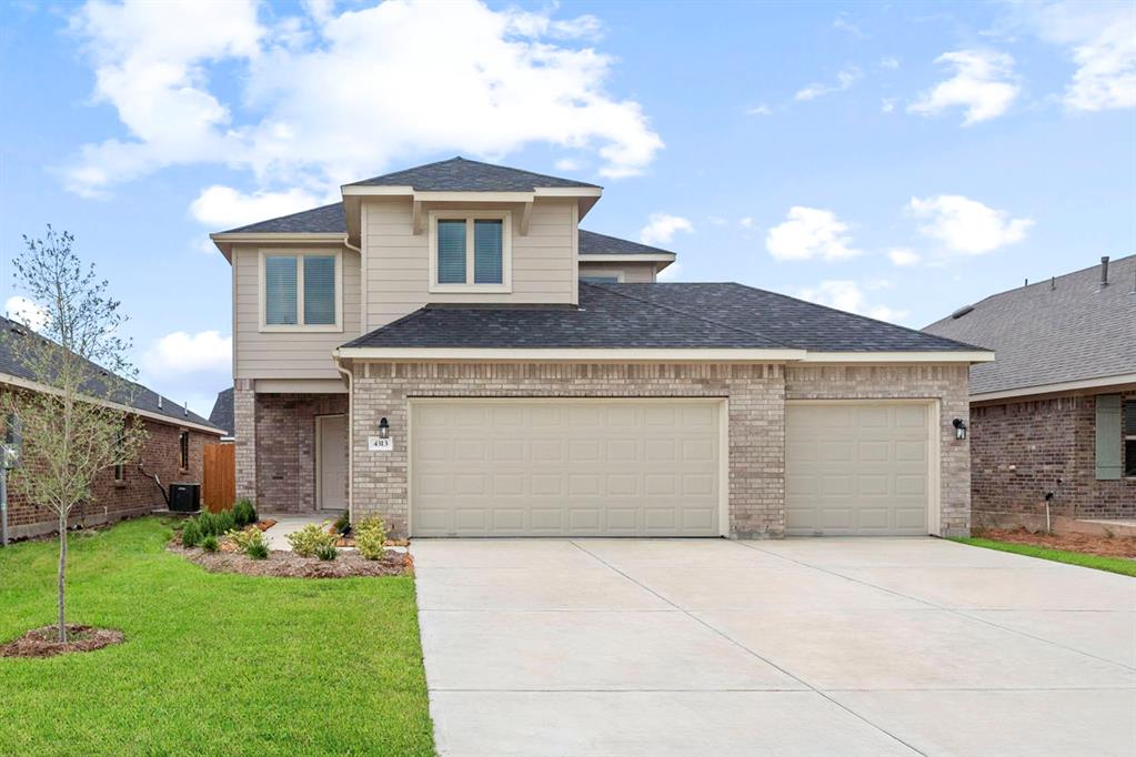 a front view of a house with a garden and garage