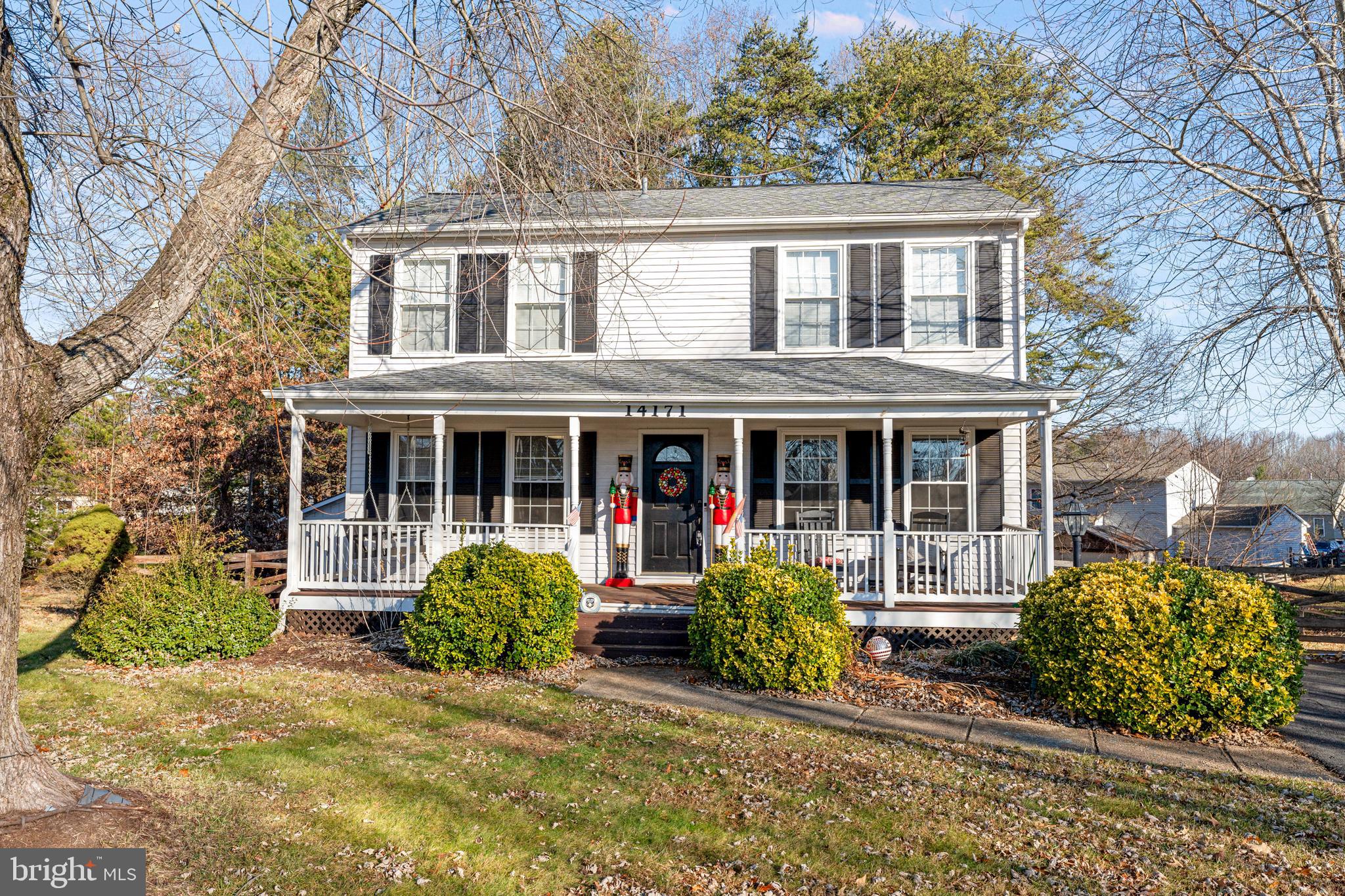 front view of a brick house with a large window and a yard