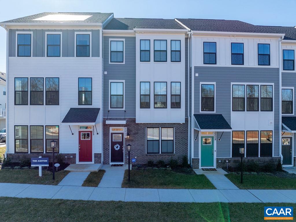 a front view of a residential apartment building with a yard