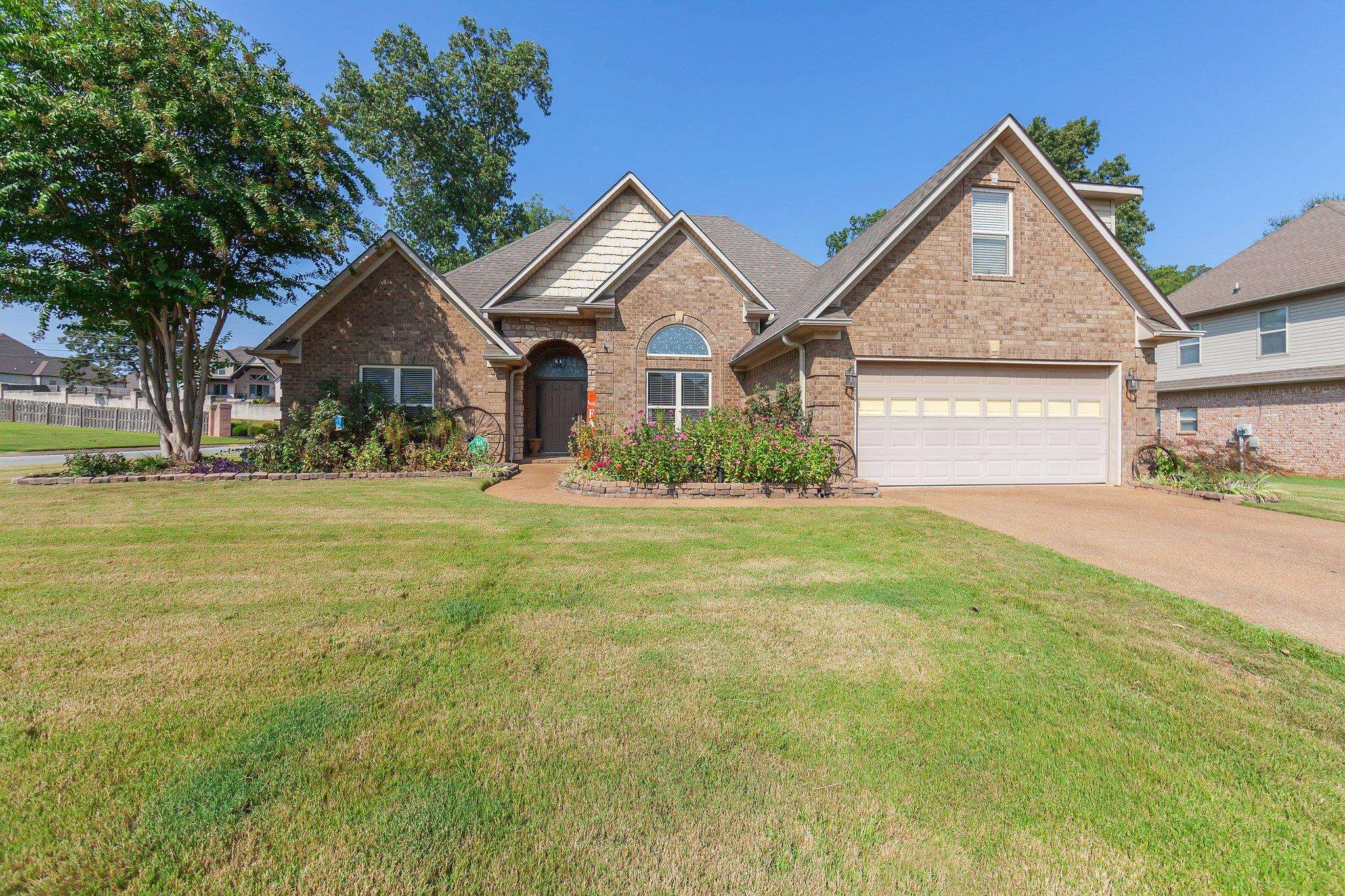 a front view of a house with a yard and garage