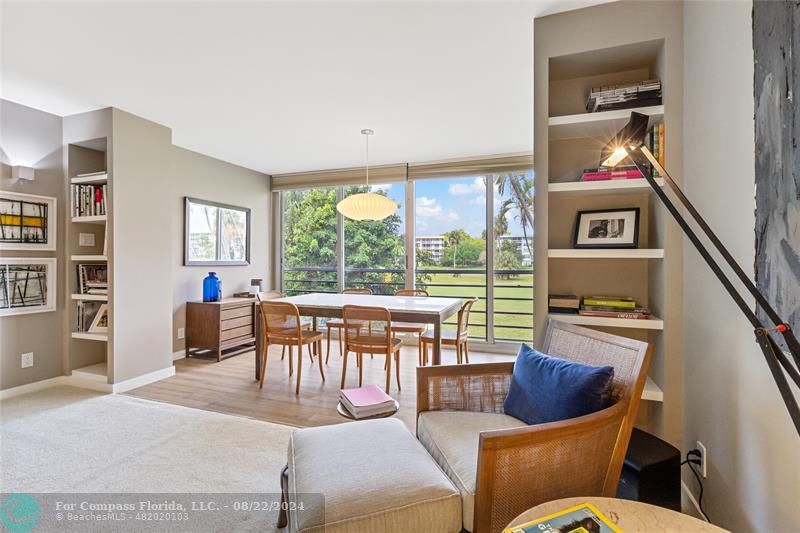 a living room with furniture and a floor to ceiling window