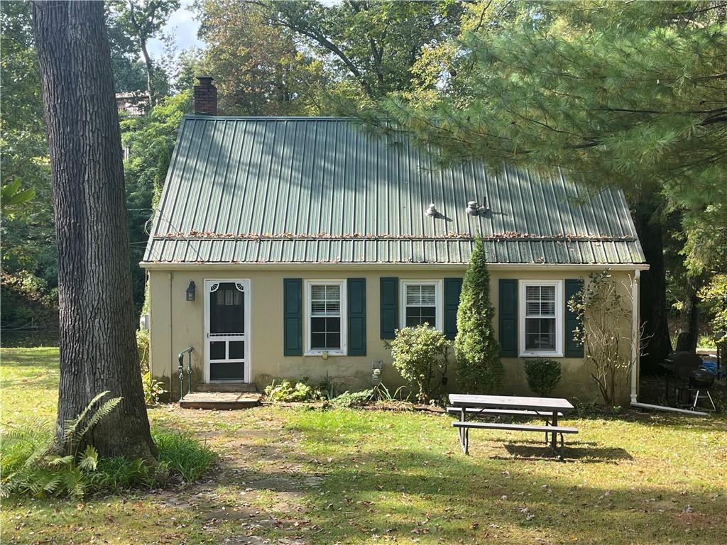 a view of a house with backyard and sitting area