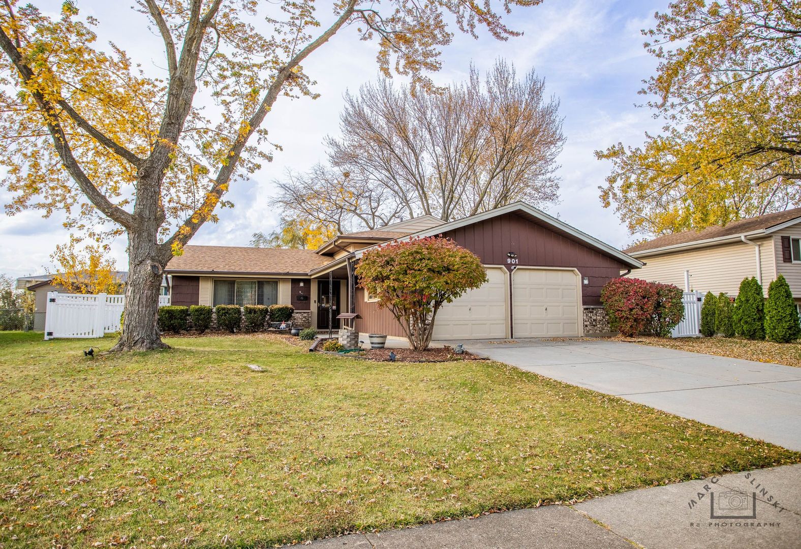 a view of a house with a yard covered with trees