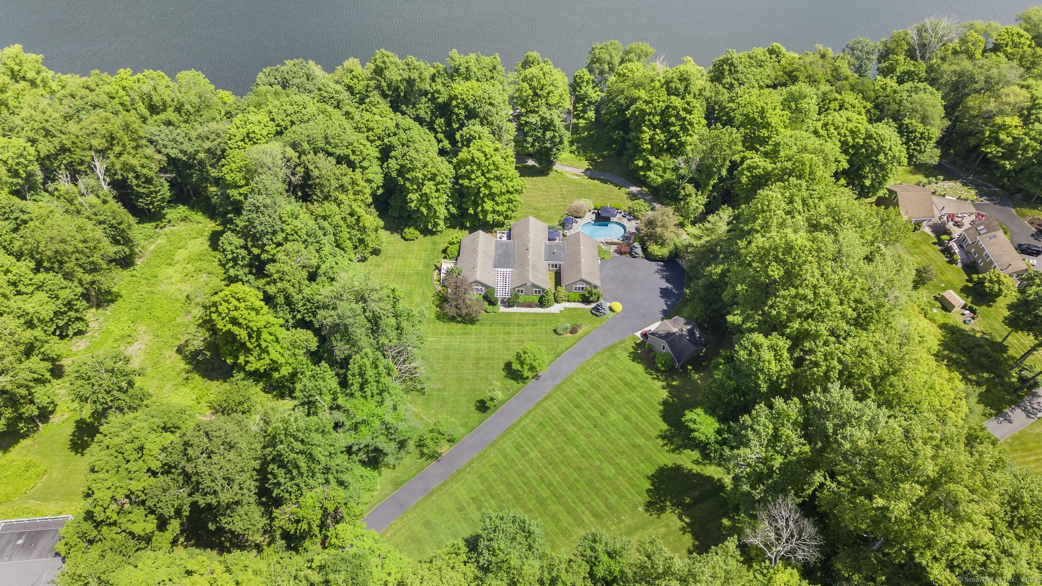 an aerial view of a house with a yard