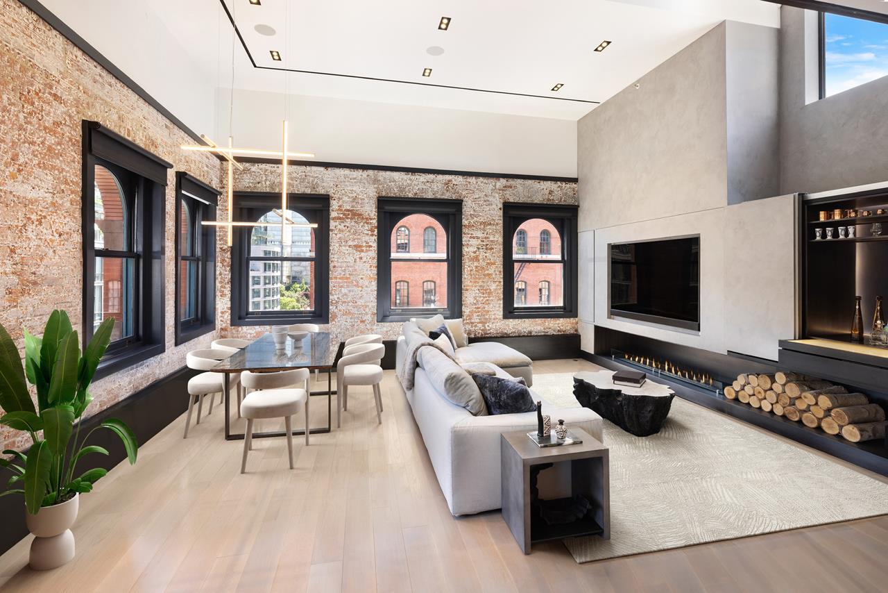 a living room with furniture a flat screen tv and a fireplace