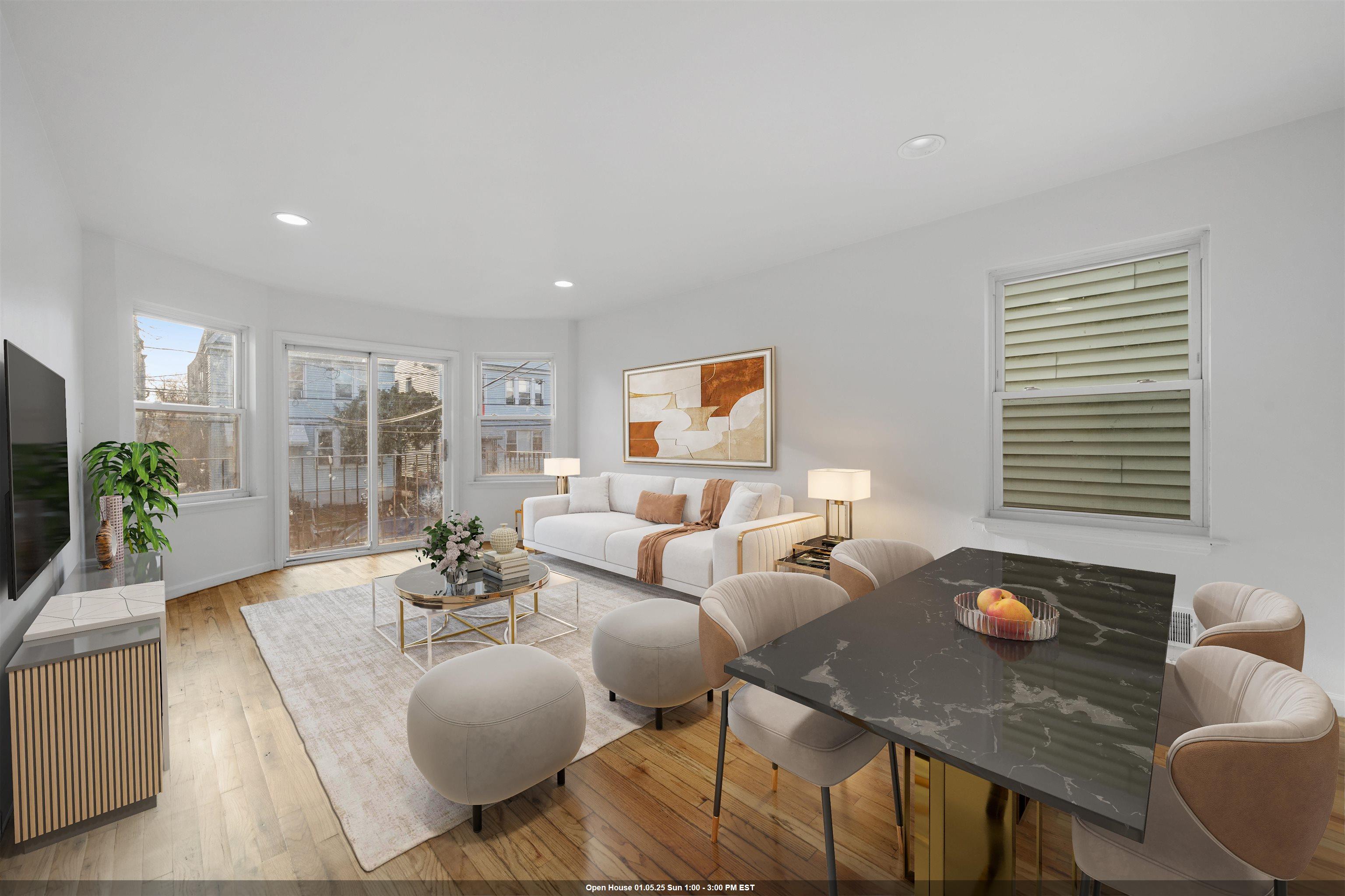 a living room with furniture potted plant and a large window