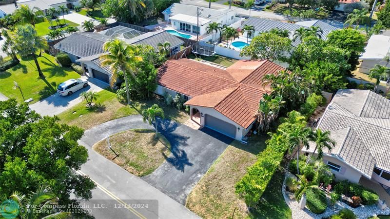 an aerial view of a house with a yard and garden