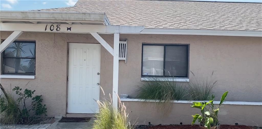 a front view of a house with plants