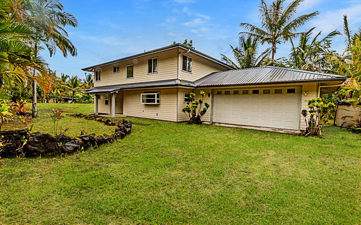 a front view of a house with a garden