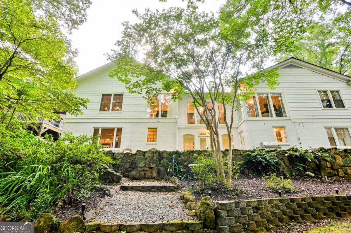 a house that has a tree in front of it