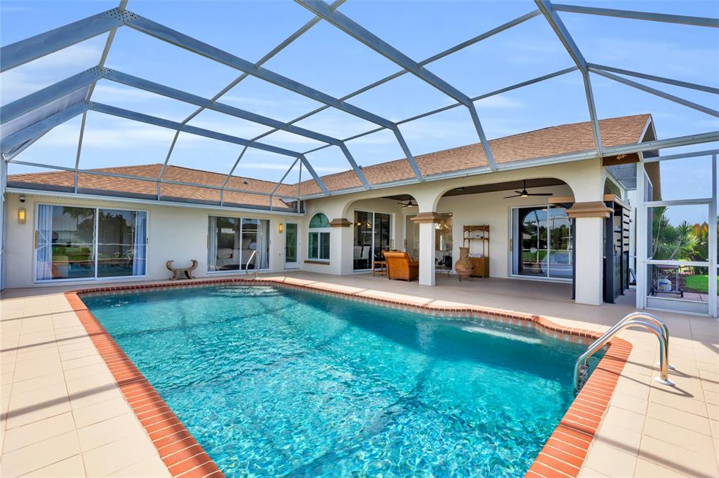 a view of a house with backyard porch and sitting area