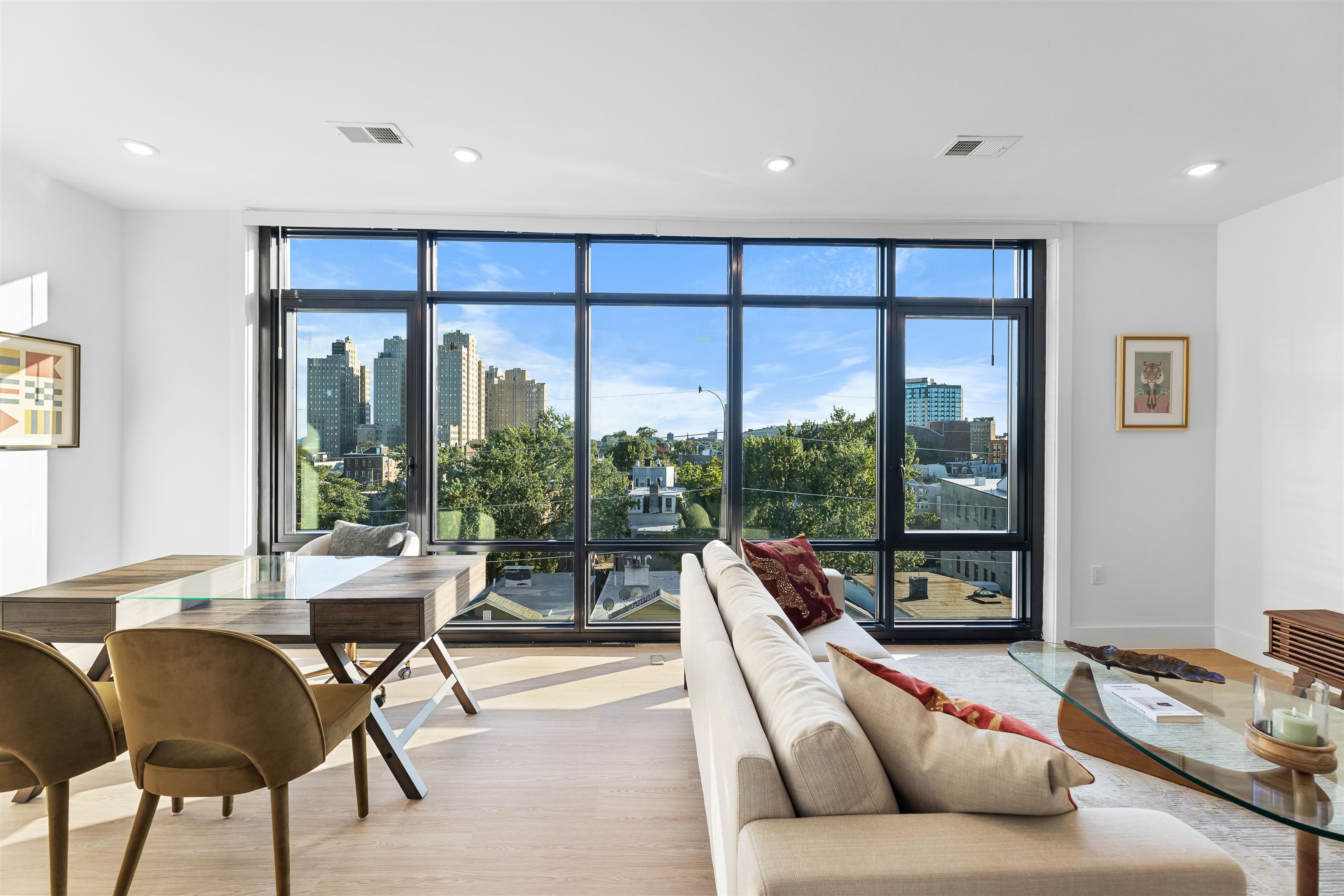 a living room with furniture and floor to ceiling windows