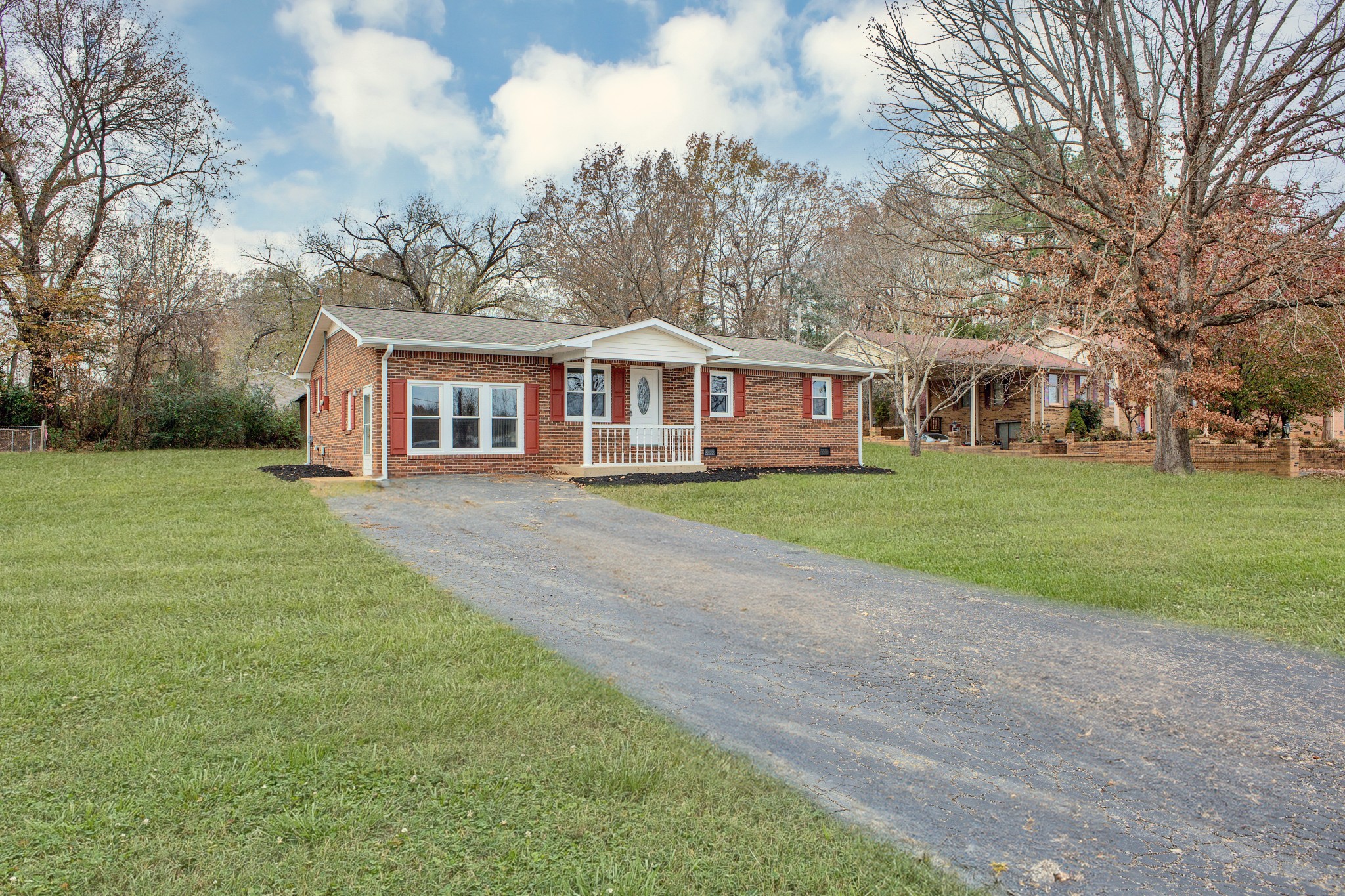 a front view of house with yard and green space