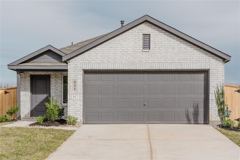 a front view of a house with garage