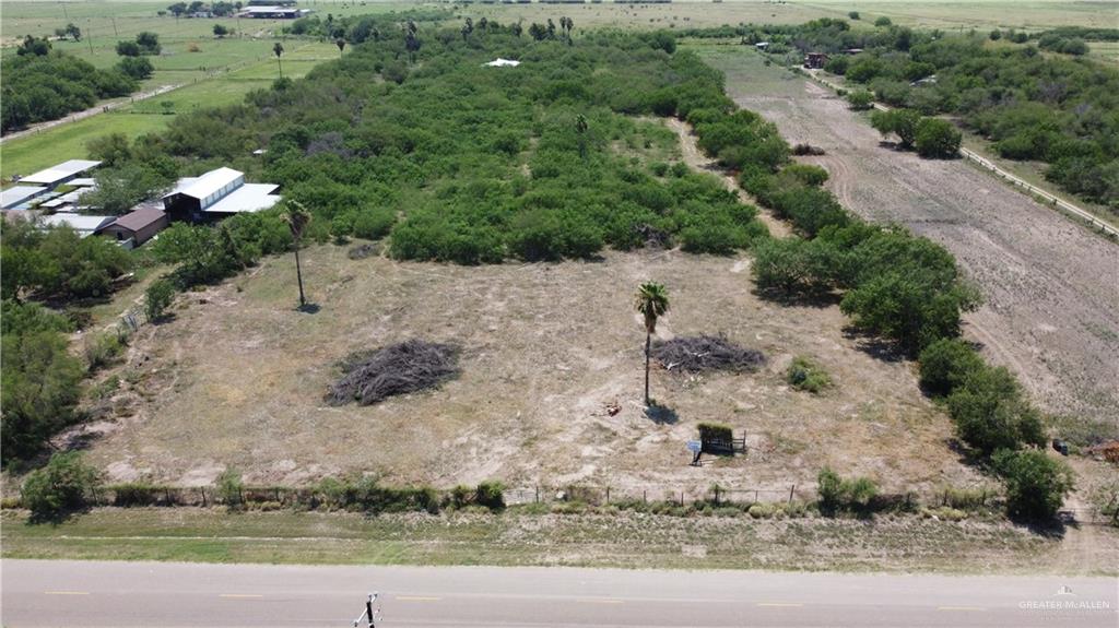 an aerial view of a house with a yard and trees