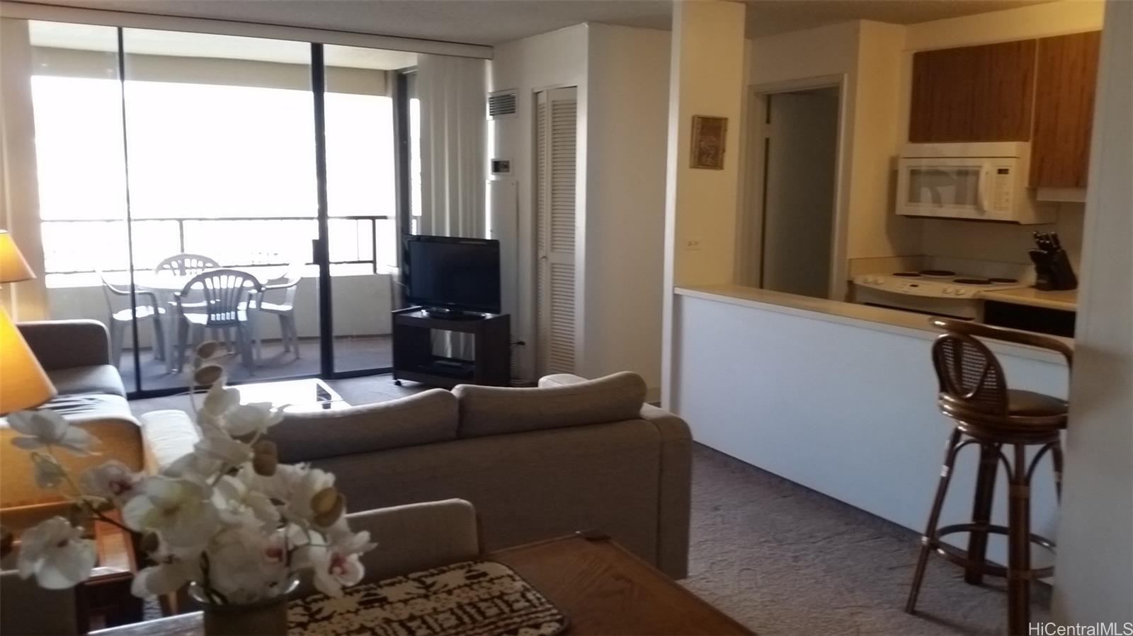 a living room with furniture a window and a flat screen tv