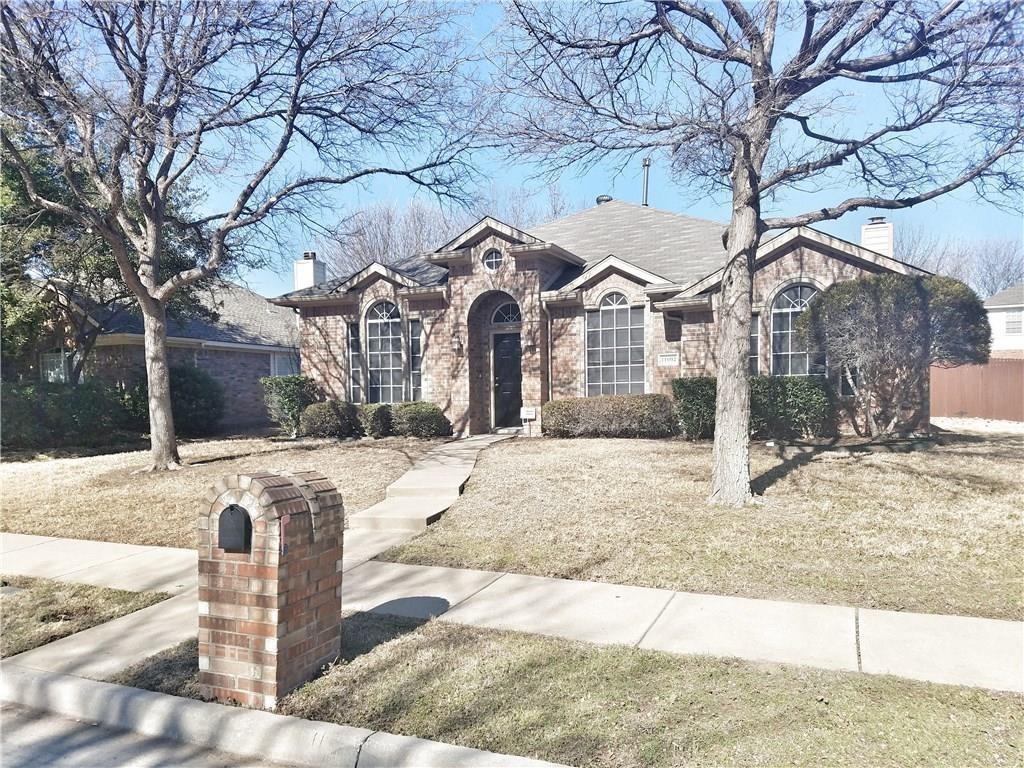 a front view of a house with a yard covered in snow