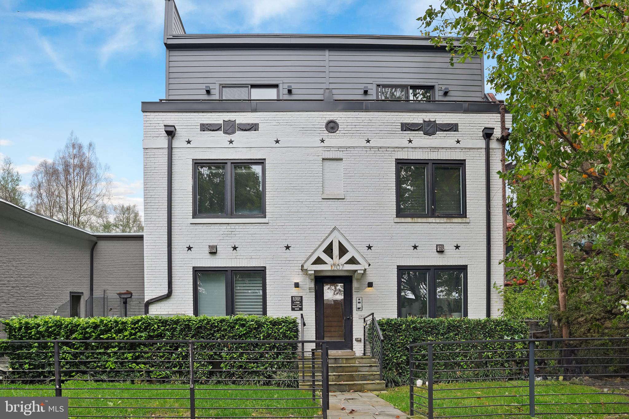 a front view of a house with a garden