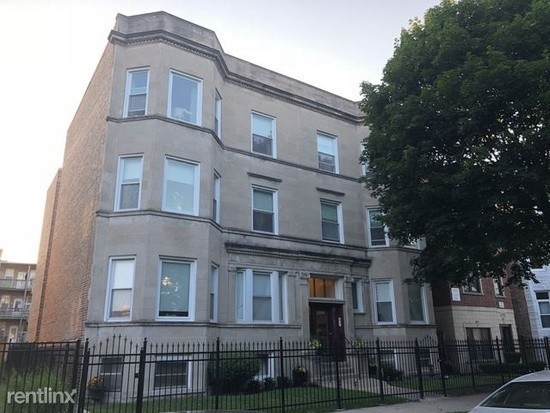 a front view of a residential apartment building with a yard