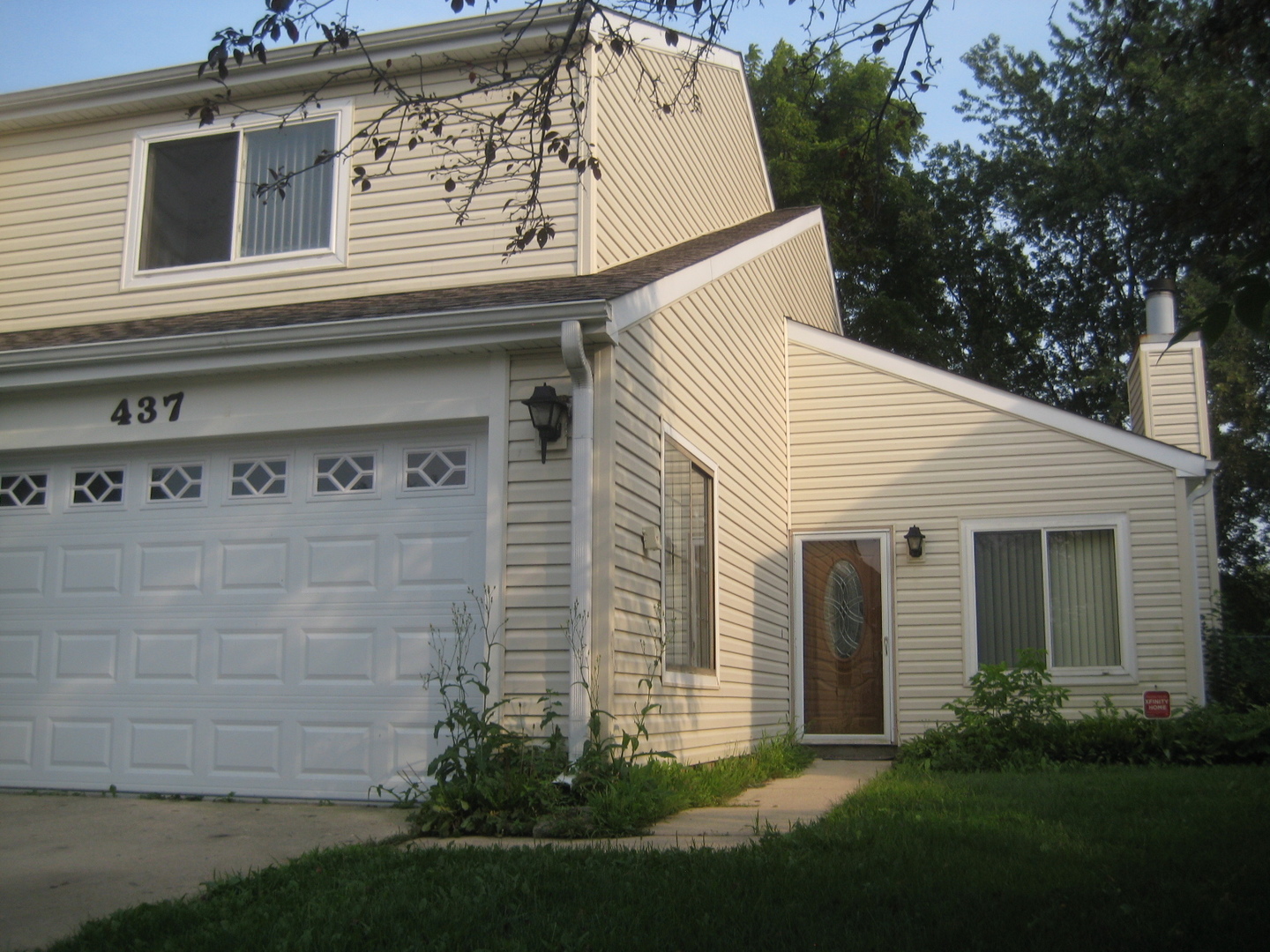 a view of a house with garage and yard