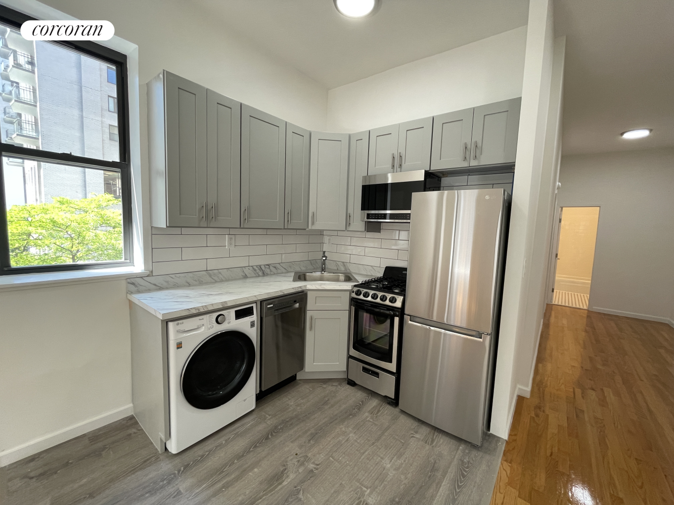 a kitchen with a refrigerator sink and stove top oven