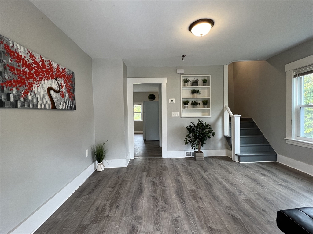 wooden floor in an empty room with a window