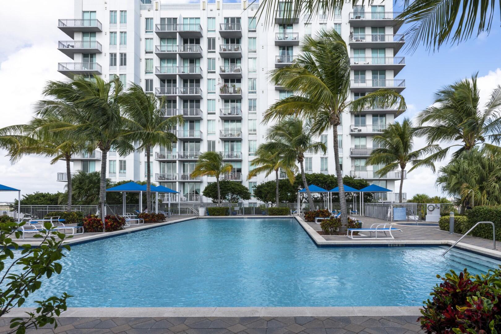 a view of a swimming pool with a lawn chairs and a lawn chairs